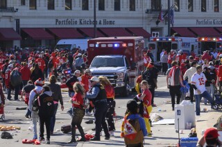 Police clear the area following a shooting at the Kansas City Chiefs NFL football Super Bowl celebration in Kansas City, Mo., Wednesday, Feb. 14, 2024. Social media users are sharing false information about suspect identification related to the shooting. (AP Photo/Reed Hoffmann)