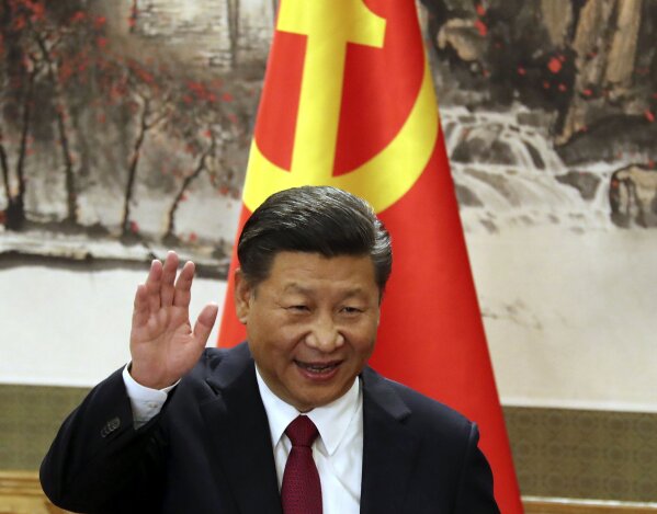 
              FILE - In this Oct. 25, 2017, file photo, Chinese President Xi Jinping waves while addressing the media as he introduced new members of the Politburo Standing Committee at Beijing's Great Hall of the People. China's official news agency said Sunday, Feb. 25, 2018, the ruling Communist Party proposed removing a limit of two consecutive terms for the country's president and vice president. The move, if approved, appears to lay the groundwork for party leader Xi to rule as president beyond 2023. (AP Photo/Ng Han Guan, File)
            