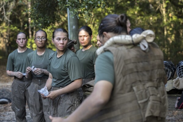 Members of a platoon of female U.S. Marine Corps recruits gear up before training in hand-to-hand combat at the Marine Corps Recruit Depot, Thursday, June 29, 2023, in Parris Island, S.C. (AP Photo/Stephen B. Morton)