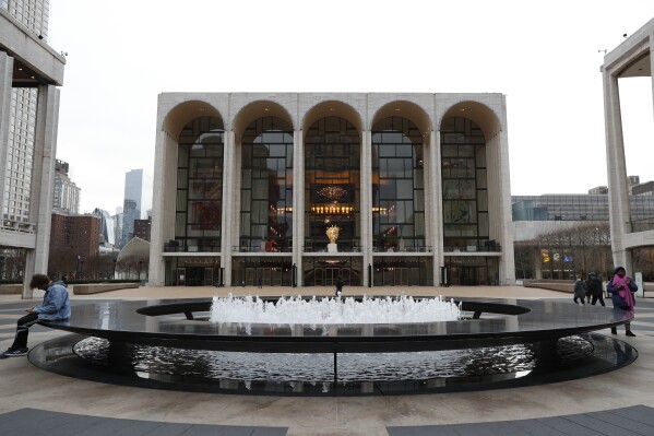 FILE - The Metropolitan Opera house, background center, appears at Lincoln Center in New York on March 12, 2020. Opera News, an 87-year-old publication focused on the Metropolitan Opera and spotlighting the art form in the U.S., will print its final issue in November and be incorporated into Britain-based Opera magazine. (AP Photo/Kathy Willens, File)