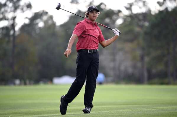 Charlie Woods watches his shot from the 14th fairway during the final round of the PNC Championship golf tournament, in Orlando, Fla., Dec. 22, 2024. (AP Photo/Phelan M. Ebenhack, File)