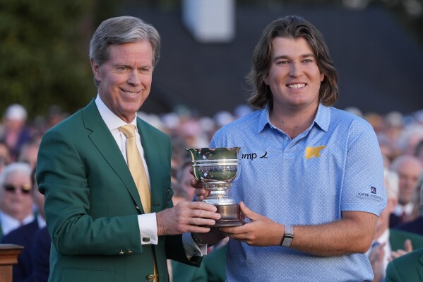 Neal Shipley, low amateur poses with Fred Ridley, chairman of Augusta National Golf Club, after winning the Masters golf tournament Sunday, April 14, 2024, in Augusta, Ga. (AP Photo/David J. Phillip)