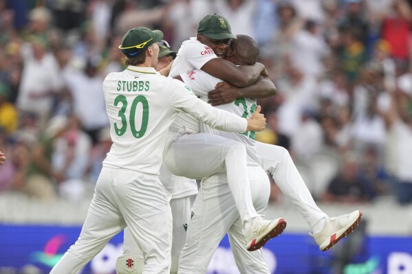 South Africa's Lungi Ngidi, right, celebrates with teammate Kagiso Rabada after the dismissal of Australia's Steve Smith on day two of the World Test Championship final between South Africa and Australia at Lord's cricket ground in London, Thursday, June 12, 2025. (AP Photo/Kirsty Wigglesworth)