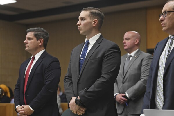 State Trooper Brian North stands in Connecticut Superior Court at the start of the eighth day of his trial in Milford, Conn., Wednesday, March 13, 2024. North is charged with manslaughter for shooting 19-year-old Mubarak Soulemane in January 2020 in West Haven after a chase from Norwalk on Interstate 95. (Ned Gerard/Hearst Connecticut Media via AP, Pool)