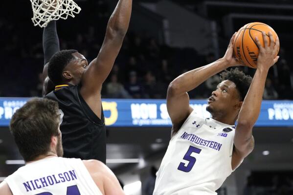 Northwestern guard Julian Roper II, right, shoots against Prairie View A&M forward Braden Bell during the second half of an NCAA college basketball game in Evanston, Ill., Sunday, Dec. 11, 2022. (AP Photo/Nam Y. Huh)