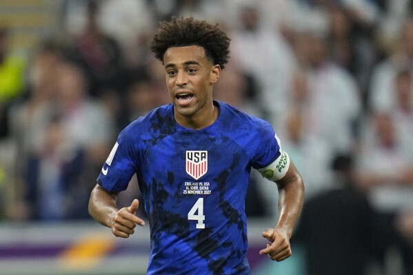 FILE - Tyler Adams of the United States runs on the pitch during the World Cup group B soccer match between England and The United States, at the Al Bayt Stadium in Al Khor, Qatar, Nov. 25, 2022. Tyler Adams, Gio Reyna, Matt Turner and Tim Ream will be given the three weeks ahead of the Copa America to regain sharpness during U.S. team training after seeing little playing time over the final three months of their club seasons. “We have friendly games to build up their fitness and get them ready,” U.S. coach Gregg Berhalter said Monday, May 20, 2024, after announcing a 27-man roster for pre-tournament friendlies against Colombia on June 8 at Landover, Maryland, and Brazil four days later at Orlando, Florida. (AP Photo/Julio Cortez, File)