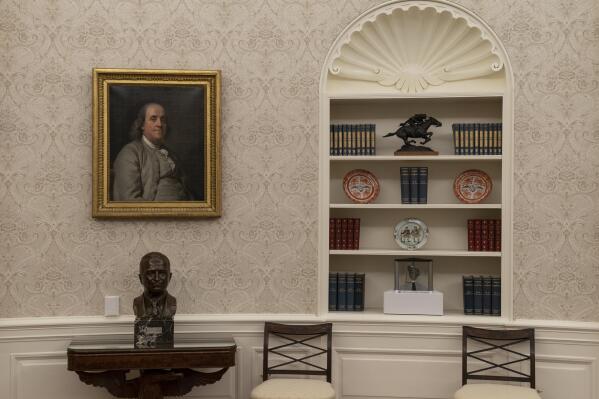 The Oval Office of the White House is newly redecorated for the first day of President Joe Biden's administration, Wednesday, Jan. 20, 2021, in Washington. On the the table is a bust of former President Harry Truman. (AP Photo/Alex Brandon)