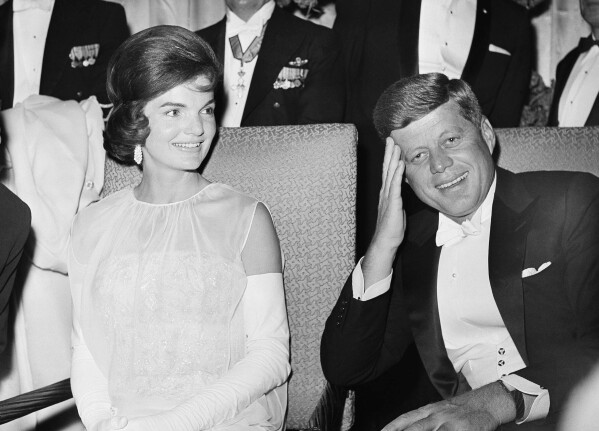 FILE - President John F. Kennedy, right, and first lady Jacqueline Kennedy are seated as they attend one of five inaugural balls, Jan. 20, 1961, in Washington. (AP Photo, File)