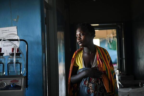 A woman in labour, walks to her delivery bed at Malawi Government's Mauwa Health Centre labour ward in Chiradzulu, southern Malawi, Sunday, May 23, 2021 . Health officials in Malawi say fewer women are getting prenatal care amid the COVID-19 pandemic. At risk are the developing country's gains on its poor rate of maternal deaths. (AP Photo/Thoko Chikondi)