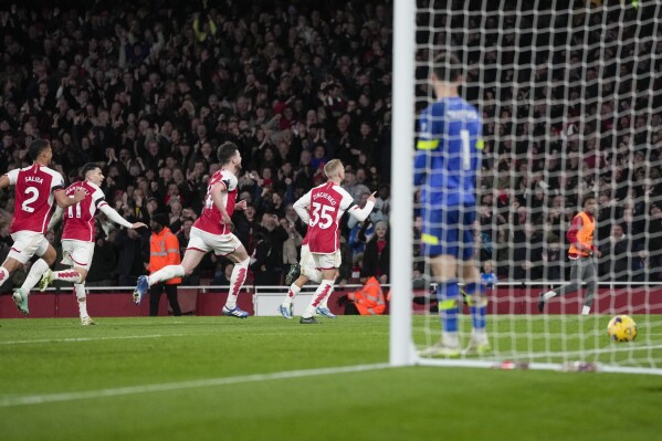 Arsenal's Oleksandr Zinchenko, center, celebrates scoring his side's 3rd goal during the English Premier League soccer match between Arsenal and Burnley at Emirates stadium in London, England, Saturday, Nov. 11, 2023. (AP Photo/Kin Cheung)