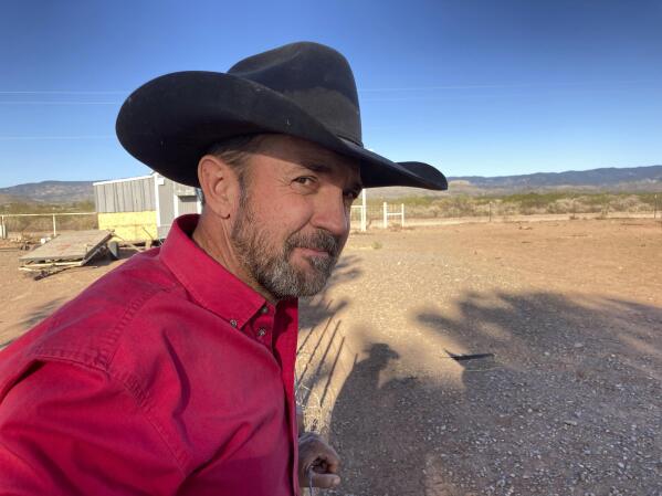 Otero County Commissioner Couy Griffin, the founder of Cowboys for Trump, takes in the view from his ranch in Tularosa, N.M., on Wednesday, May 12, 2021. Griffin is reviled and revered in politically conservative Otero County as he confronts criminal charges for joining protests on an outdoor terrace of the U.S. Capitol on Jan. 6. He's also fighting for his political future amid a recall initiative and state probes into his finances. (AP Photo/Morgan Lee)