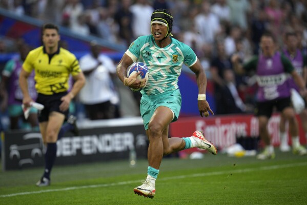 South Africa's Kurt-Lee Arendse runs in to score a try during the Rugby World Cup Pool B match between South Africa and Scotland at the Stade de Marseille in Marseille, France, Sunday, Sept. 10, 2023. (AP Photo/Daniel Cole)