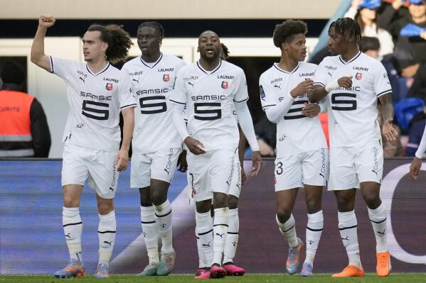 Rennes' Karl Toko Ekambi, center, celebrates after scoring his side's first goal during the French League One soccer match between Paris Saint-Germain and Rennes at the Parc des Princes in Paris, Sunday, March 19, 2023. (AP Photo/Christophe Ena)