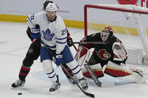 Toronto Maple Leafs' Nick Ritchie (20) screens Ottawa Senators goaltender Anton Forsberg (31) as Senators' Nick Holden defends during the first period of an NHL hockey game Thursday, Oct. 14, 2021, in Ottawa, Ontario. (Adrian Wyld/The Canadian Press via AP)