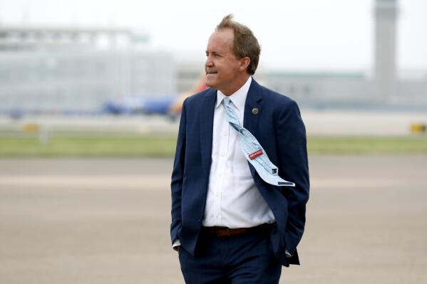 FILE - In this June 28, 2020 file photo, Texas State's Attorney General Ken Paxton waits on the flight line for the arrival of Vice President Mike Pence at Love Field in Dallas. Republican U.S. Sen. John Cornyn of Texas on Thursday blasted Paxton, one of his party's top leaders back home, calling a mounting pile of accusations and legal woes an "embarrassment" just days before a primary runoff election. (AP Photo/Tony Gutierrez, File)