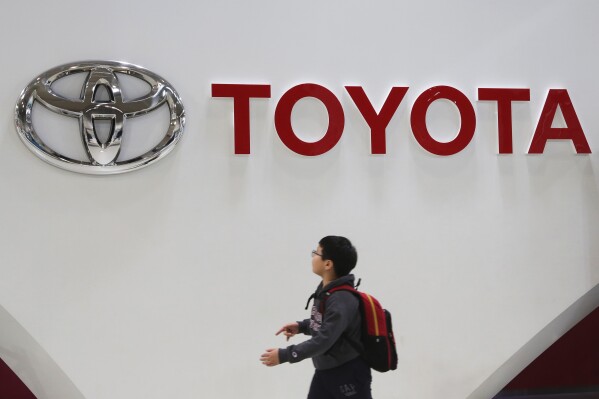 FILE - A boy looks at a logo of Toyota Motor Corp. at its gallery in Tokyo on Jan. 15, 2020. Toyota’s profit for the first fiscal quarter jumped to 1.3 trillion yen ($9 billion) — a quarterly record for Japan’s top automaker, as sales grew and parts shortages related to the coronavirus pandemic eased. Toyota Motor Corp.’s April-June, 2023, net profit rose 78% from 736.8 billion yen the previous year, the company reported Tuesday, Aug. 1, 2023.(AP Photo/Koji Sasahara, File)