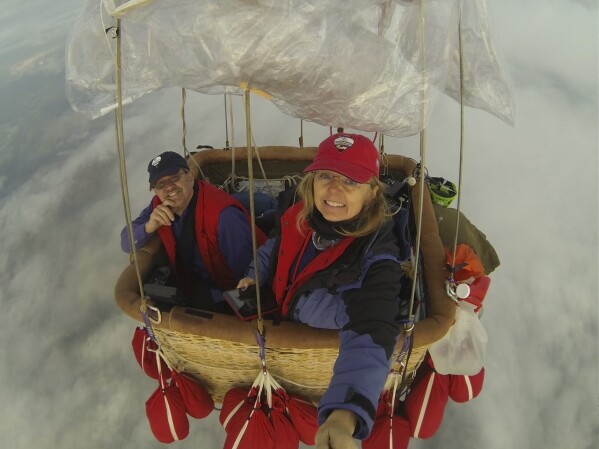 In a May 11, 2012 image provided by Cheri White, Cheri White and Mark Sullivan fly their gas balloon. It's been 15 years since the world's elite gas balloon pilots have gathered in the United States for the Coupe Gordon Bennett, a long-distance race whose roots stretch back more than a century. White and Sullivan will be participating in the 2023 Gordon Bennett competition. The flight window opens Saturday, Oct. 7. (Cheri White via AP)