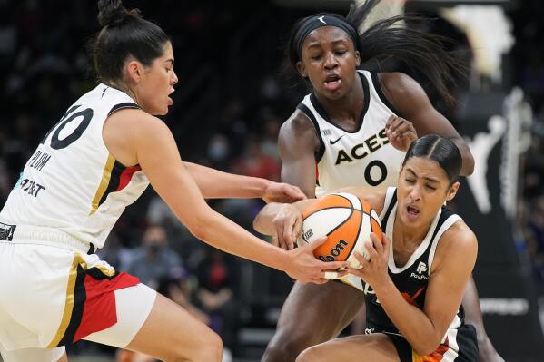 Phoenix Mercury guard Skylar Diggins-Smith vies for the ball with Las Vegas Aces guard Kelsey Plum and guard Jackie Young (0) during the first half of Game 4 of a WNBA basketball playoff series Wednesday, Oct. 6, 2021, in Phoenix. (AP Photo/Rick Scuteri)