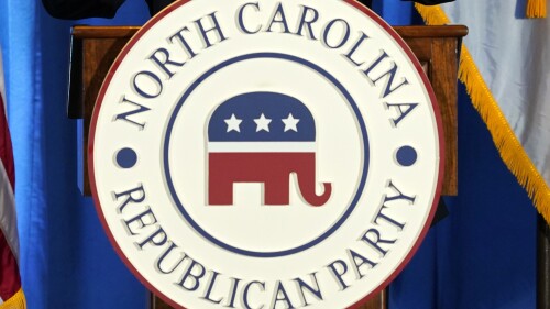 FILE - The North Carolina Republican Party logo is shown as Republican presidential candidate and former Vice President Mike Pence speaks during the North Carolina Republican Party Convention in Greensboro, N.C., June 10, 2023. On Monday, July 17, three North Carolina Republican activists filed suit for new state party leadership elections to be conducted after they say voting procedures and other rules governing last month’s state convention were violated. (AP Photo/Chuck Burton, File)