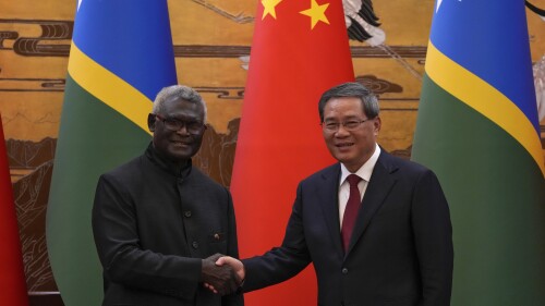 Visiting Solomon Islands Prime Minister Manasseh Sogavare, left, shakes hands with his Chinese counterpart Li Qiang after they witnessed signing on agreement for both countries at the Great Hall of the People in Beijing, Monday, July 10, 2023. (AP Photo/Andy Wong, Pool)