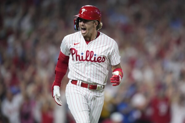 Philadelphia Phillies' Bryson Stott reacts after hitting a grand slam against Miami Marlins pitcher Andrew Nardi during the sixth inning of Game 2 in an NL wild-card baseball playoff series, Wednesday, Oct. 4, 2023, in Philadelphia. (AP Photo/Matt Slocum)