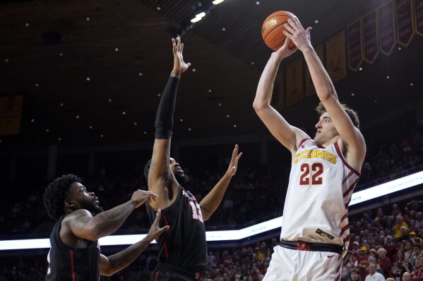 Iowa State forward Milan Momcilovic (22) shoots over Houston guard Jamal Shead, left, and forward J'Wan Roberts (13) during the second half of an NCAA college basketball game, Tuesday, Jan. 9, 2024, in Ames, Iowa. Iowa State won 57-53. (AP Photo/Charlie Neibergall)