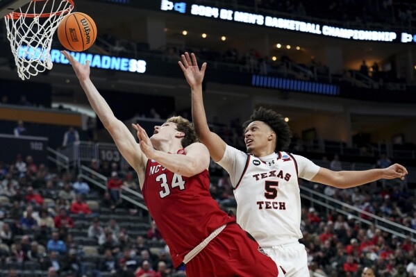 North Carolina State's Ben Middlebrooks (34) shoots against Texas Tech's Darrion Williams (5) during the second half of a college basketball game in the first round of the men's NCAA Tournament on Thursday, March 21, 2024, in Pittsburgh. (AP Photo/Matt Freed)