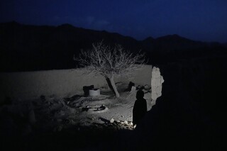 A boy who lost his parents and five of his siblings during a Sept. 5, 2019, night raid by U.S. forces, stands in the yard of their home that was destroyed in the attack in a remote region of Afghanistan, on Friday, Feb. 24, 2023. What exactly happened that fall night is at the center of a bitter international custody dispute over an orphaned baby found amid the rubble. The high-profile legal battle pits an Afghan family against an American one, and has drawn responses from the White House and the Taliban. (AP Photo/Ebrahim Noroozi)
