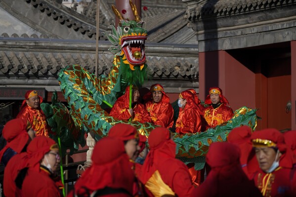 Chinese dragon dancers and performers dressed in traditional costumes wait to participate in a performance at the Dongyue Temple during the first day of the Chinese Lunar New Year in Beijing, Saturday, Feb. 10, 2024. (AP Photo/Andy Wong)