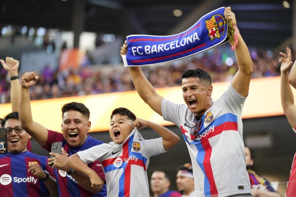 Fans cheer before a Champions Cup soccer match between FC Barcelona and Arsenal FC, Wednesday, July 26, 2023, in Inglewood, Calif. (AP Photo/Ashley Landis)