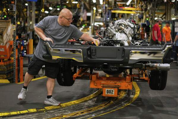 Vehicle assembly technician Kevin Zepernick works on a 2025 Ford Expedition during a media tour to launch the 2025 Ford Expedition at the Ford Motor Company Kentucky Truck Plant, Wednesday, April 30, 2025, in Louisville, Ky. (AP Photo/Carolyn Kaster, File)