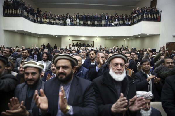 Party members listen to a speech by Afghan presidential candidate Abdullah Abdullah during a conference in Kabul, Afghanistan, Tuesday, Feb. 18, 2020. The country's independent election commission said Tuesday that Ashraf Ghani  won a second term as president, more than four months after polls closed. (AP Photo/Rahmat Gul)