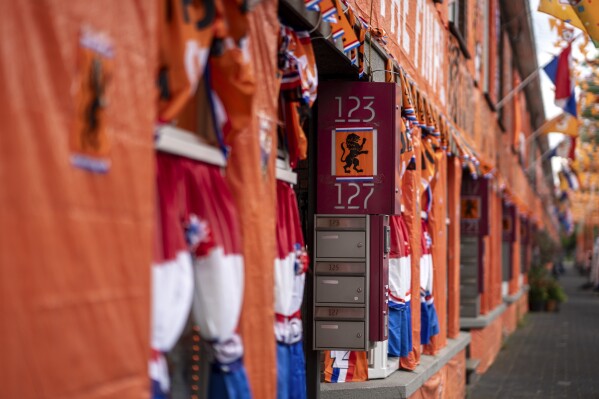 Even the mailboxes are adorned with the Dutch lion on Marktweg street, which is covered in orange tarp, orange bunting, and Dutch national flags in The Hague, Netherlands, Thursday June 13, 2024, one day ahead of the start of the Euro 2024 Soccer Championship. (AP Photo/Peter Dejong)