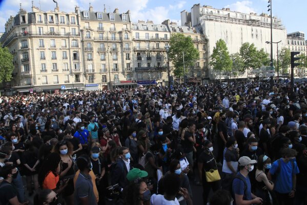 Protesters gather Tuesday, June 2, 2020 in Paris. Thousands of people defied a police ban and converged on the main Paris courthouse for a demonstration to show solidarity with U.S. protesters and denounce the death of a black man in French police custody. The demonstration was organized to honor Frenchman Adama Traore, who died shortly after his arrest in 2016, and in solidarity with Americans demonstrating against George Floyd's death. (AP Photo/Michel Euler)