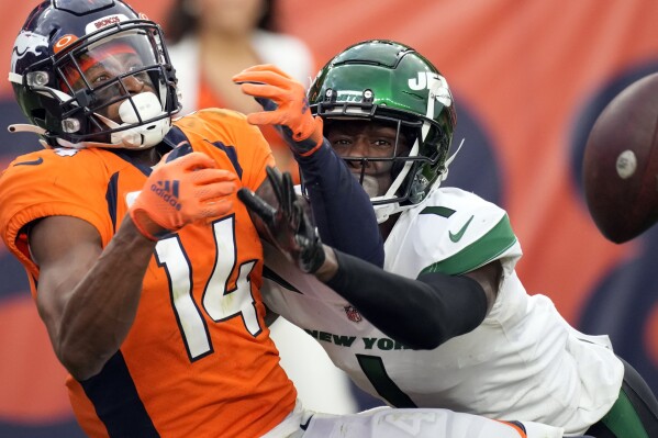 FILE - New York Jets cornerback Sauce Gardner (1) breaks up a pass intended for Denver Broncos wide receiver Courtland Sutton (14) in the end zone during the second half of an NFL football game Oct. 23, 2022, in Denver. Gardner, who turns 23 on Thursday, quickly established himself as a shutdown cornerback in the NFL. (AP Photo/David Zalubowski, File)
