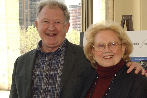 FILE - Harvey Evans, left, and Barbara Cook arrive for a dress rehearsal of the New York Philharmonic's presentation of "Candide" the musical at Lincoln Center in New York on Tuesday, May 4, 2004. Evans, an actor, singer and dancer who managed to land roles in the original Broadway productions of such classics as “West Side Story,” “Follies” “Hello, Dolly!” and “Gypsy,” died on Friday, Dec. 24, 2021. He was 80. (AP Photo/Dean Cox, File)