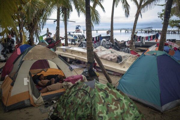 Migrants camp on the beach, in Necocli, Colombia, Saturday, Oct. 7, 2023. New York City Mayor Eric Adams has capped off a four-day trip to Latin America with a visit to the northern Colombian city where thousands of migrants start the trek across the Darien jungle, as they head to the United States. (AP Photo/Ivan Valencia)