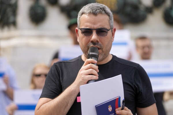 Peter Nikitin, a Russian pro-democracy activist residing in Serbia, speaks during a gathering in Belgrade, Serbia, Sunday, July 30, 2023. Russian antiwar supporters in Serbia held a protest on Sunday after two prominent activists and critics of Russian President Vladimir Putin had problems with entry and residence permits in the Balkan country. Activists held banners reading “We came to leave in peace” and ”I love Serbia and I want a safe and happy life here,” as they gathered at a central square in the Serbian capital. (AP Photo/Darko Vojinovic)