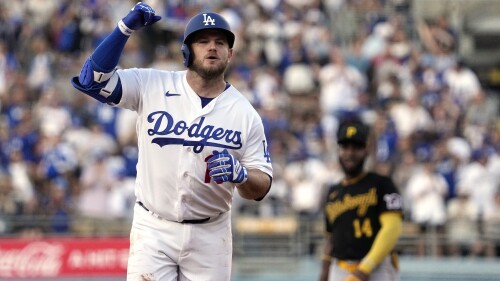 Los Angeles Dodgers' Max Muncy, left, celebrates as he heads to third after hitting a solo home run while Pittsburgh Pirates shortstop Rodolfo Castro watches during the second inning of a baseball game Monday, July 3, 2023, in Los Angeles. (AP Photo/Mark J. Terrill)