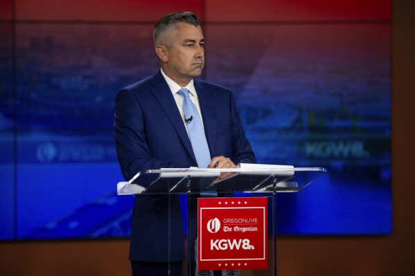 Nathan Vasquez responds to Multnomah County District Attorney Mike Schmidt, not seen, during a candidate debate hosted by The Oregonian and KGW news at KGW's studio the evening of Thursday., May 2, 2024 in Portland, Ore. Schmidt is seeking a second term, while Vasquez currently works for Schmidt as a senior deputy district attorney. (Dave Killen /The Oregonian via AP)