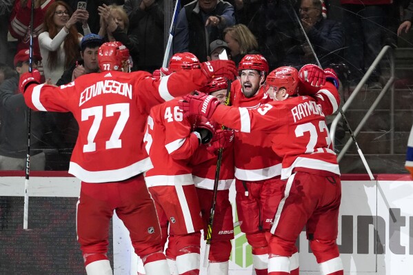Detroit Red Wings center Dylan Larkin, second from right, celebrates his goal against the New York Islanders in the second period of an NHL hockey game Thursday, March 21, 2024, in Detroit. (AP Photo/Paul Sancya)
