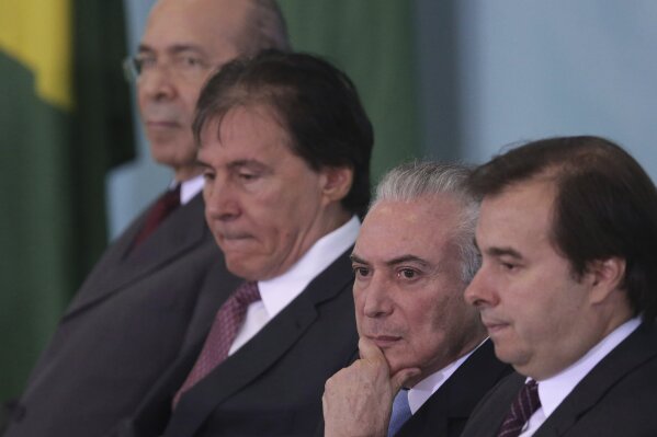 
              Brazil's President Michel Temer, second right, sits next to President of the Chamber of Deputies Rodrigo Maia, right, and the President of the National Congress Eunicio Oliveira, second left, and his Chief of Staff Eliseu Padilha, as they attend a ceremony at the Planalto Presidential Palace, in Brasilia, Brazil, Wednesday, June 7, 2017. Brazil's top electoral court is returning to its examination of illegal campaign finance allegations that could force President Michel Temer from office. (AP Photo/Eraldo Peres)
            