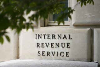 FILE - A sign outside the Internal Revenue Service building is seen, May 4, 2021, in Washington. The IRS is still too slow to process amended tax returns, answer taxpayer phone calls and resolve identity theft cases, according to an independent watchdog within the agency. The organization sent a report to Congress Wednesday that the backlog of unprocessed amended returns has quadrupled from 500,000 in 2019 to 1.9 million in October last year. (AP Photo/Patrick Semansky, File)