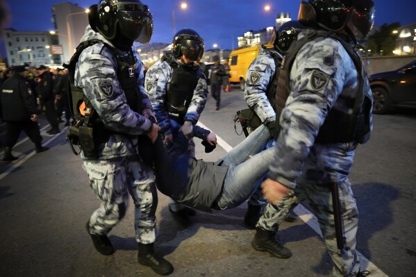 FILE -Riot police detain a demonstrator during a protest against mobilization in Moscow, Russia, Wednesday, Sept. 21, 2022. Western countries on Monday repeatedly called on Russia to end domestic repression of dissident voices and end its war in Ukraine and human rights violations related to it, as Russia came under a regular review at the U.N.’s top rights body. (AP Photo/Alexander Zemlianichenko, File)