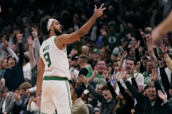Boston Celtics guard Derrick White celebrates with fans after hitting a 3-pointer in the final minute of the second half of an NBA basketball game against the Oklahoma City Thunder, Monday, Nov. 14, 2022, in Boston. (AP Photo/Charles Krupa)