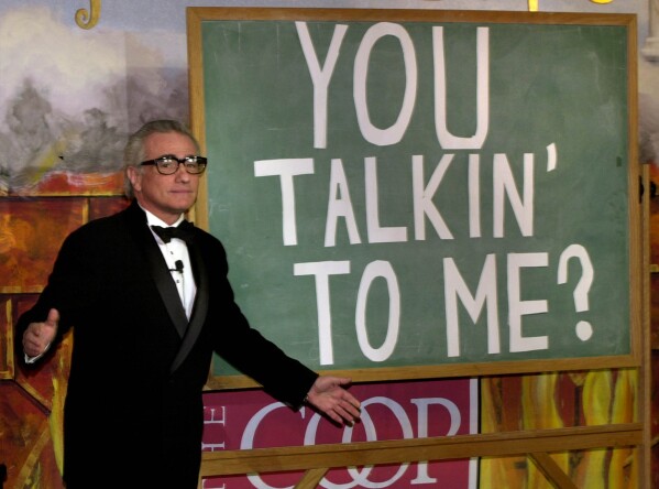Director Martin Scorsese acknowledges the proper grammar of Robert De Niro's famous line in the movie "Taxi Driver", which he directed, during a skit as he is honored by the Hasty Pudding Theatricals as their Man of the Year at Harvard University in Cambridge, Mass., Thursday, Feb. 13, 2003. (AP Photo/Charles Krupa)