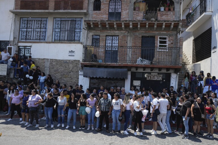 Residents gather as the coffin that contain the remains of an 8-year-old girl is delivered to family, in Taxco, Mexico, Thursday, March 28, 2024. The 8-year-old girl disappeared Wednesday; her body was found on a road on the outskirts of the city early Thursday. (AP Photo/Fernando Llano)
