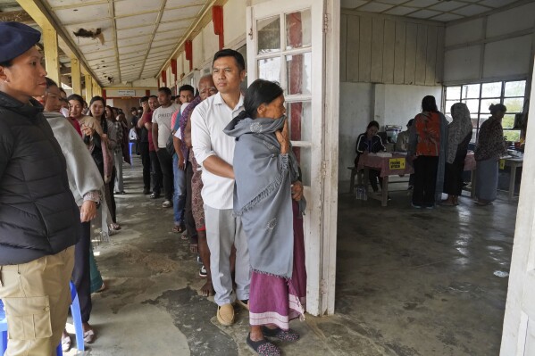 Angami Nagas stand in queues to cast their votes in Chedema village, in the northeastern Indian state of Nagaland, Friday, April 19, 2024. (AP Photo/Yirmiyan Arthur)