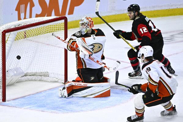 Ottawa Senators right wing Alex DeBrincat (12) watches his shot bounce in the net for a goal on Anaheim Ducks goaltender Lukas Dosta during the third period of an NHL hockey game in Ottawa, Ontario, Monday, Dec. 12, 2022. (Justin Tang/The Canadian Press via AP)