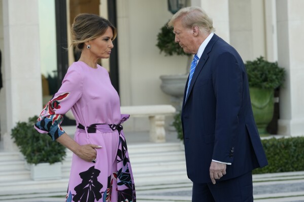 Former President Donald Trump, right, stands with Melania Trump as they arrive for a GOP fundraiser, Saturday, April 6, 2024, in Palm Beach, Fla. (AP Photo/Lynne Sladky)